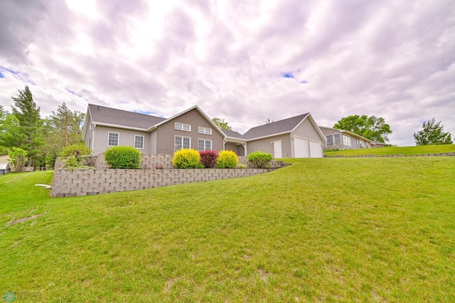 view of front of house featuring a garage and a front yard