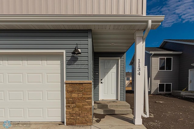 view of exterior entry with a garage