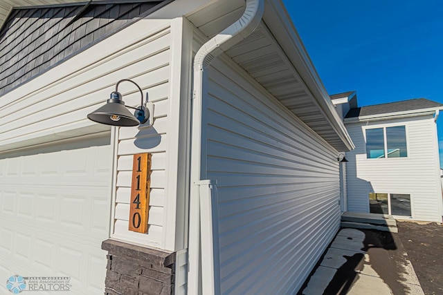 view of side of property with a garage