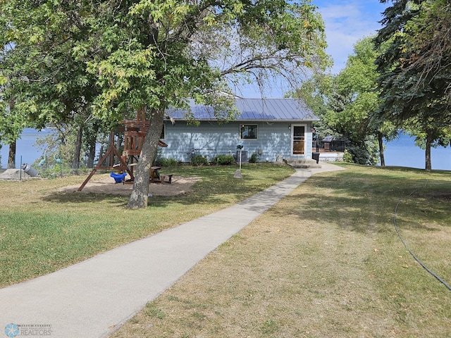 view of front of house featuring a playground and a front yard