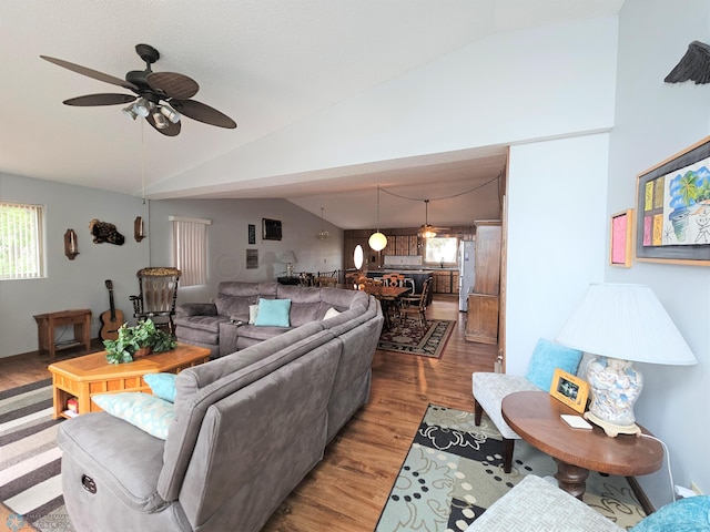 living room featuring hardwood / wood-style flooring, lofted ceiling, and ceiling fan