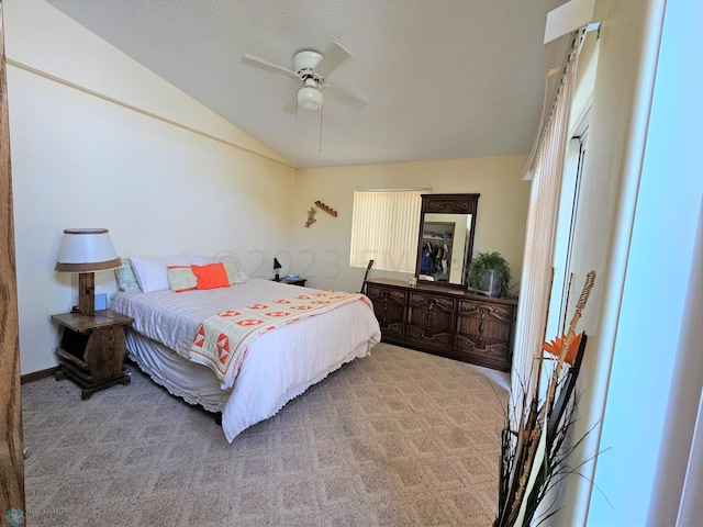 carpeted bedroom featuring ceiling fan and vaulted ceiling