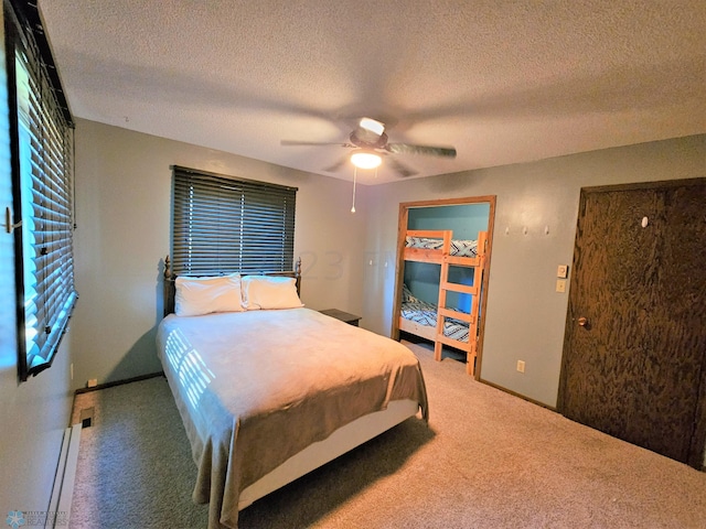 bedroom with a textured ceiling, carpet, and ceiling fan