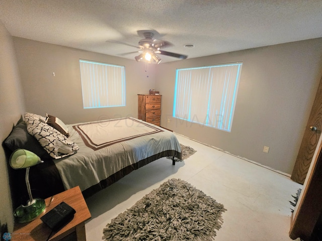 bedroom with a textured ceiling and ceiling fan