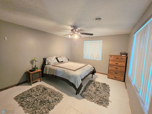 bedroom featuring a textured ceiling and ceiling fan