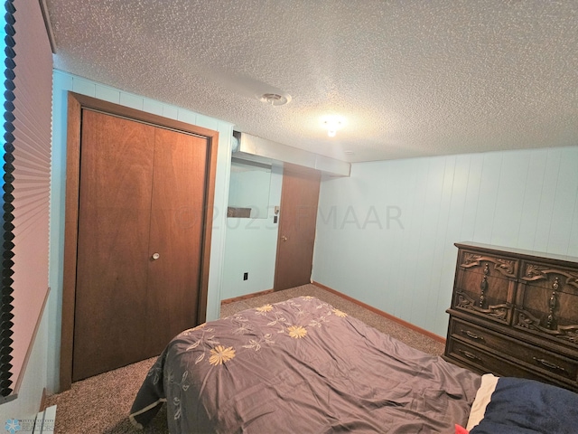 carpeted bedroom featuring a closet and a textured ceiling