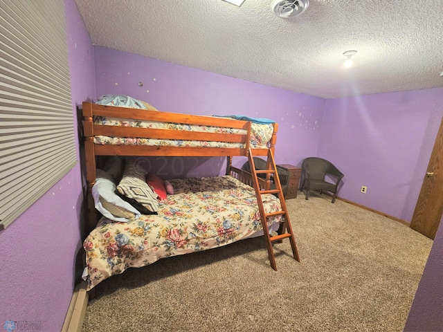 carpeted bedroom featuring a textured ceiling