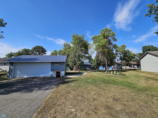 view of property exterior featuring a garage and a yard