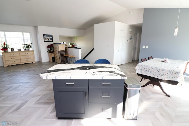 interior space featuring lofted ceiling and light parquet flooring