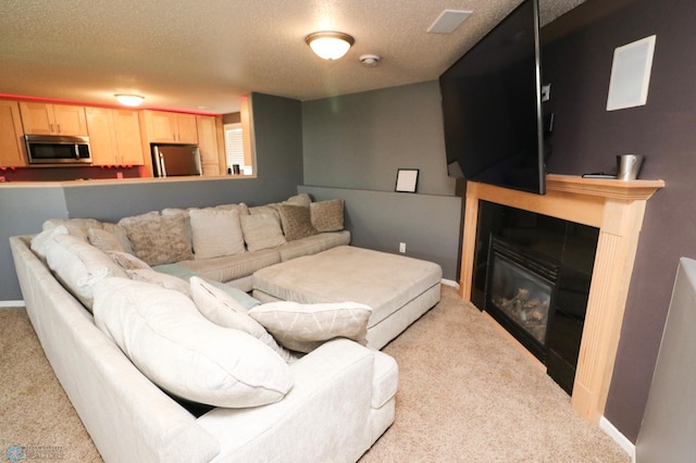 living room with light carpet and a textured ceiling