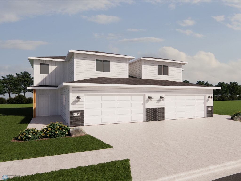 view of front of home with a front yard and a garage