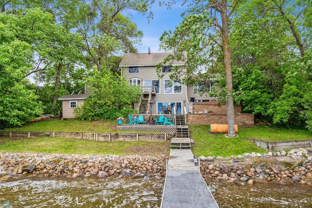 back of property with a deck with water view