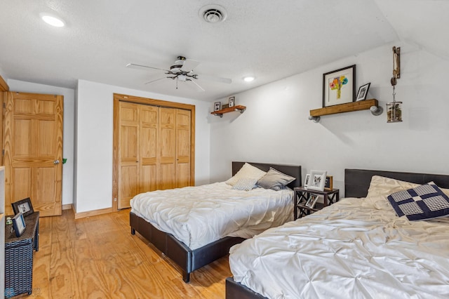 bedroom with a closet, ceiling fan, and light hardwood / wood-style floors