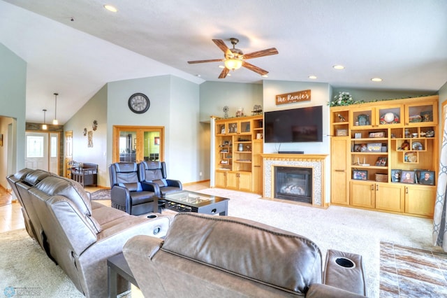 living room with high vaulted ceiling, ceiling fan, and light colored carpet