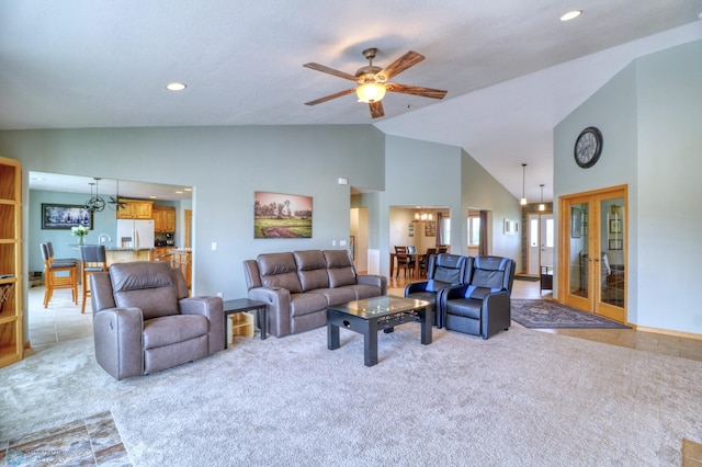 living room with high vaulted ceiling, ceiling fan, carpet floors, and french doors