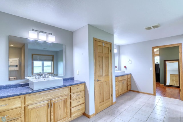 bathroom featuring tile flooring and vanity