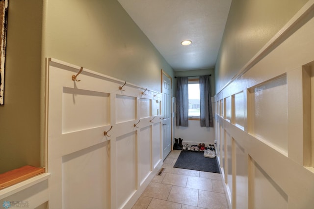 doorway to outside featuring light tile flooring