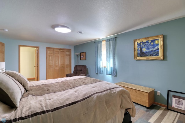 carpeted bedroom featuring a textured ceiling and a closet