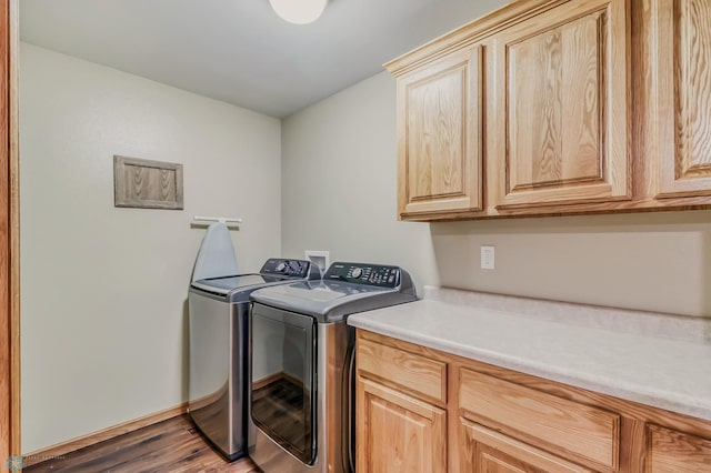 laundry area featuring washing machine and dryer, washer hookup, cabinets, and dark wood-type flooring