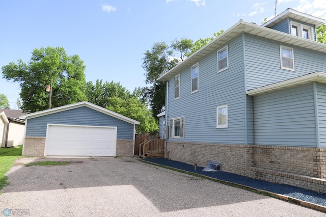 view of side of home with a garage and an outdoor structure