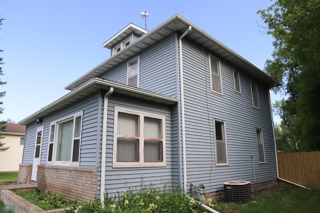 view of side of property featuring central air condition unit