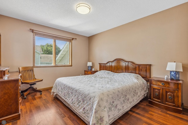 bedroom featuring a textured ceiling and dark hardwood / wood-style floors