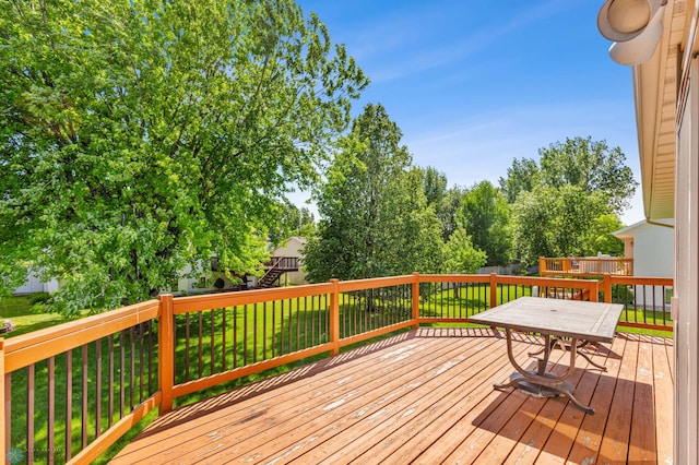 wooden deck featuring a yard