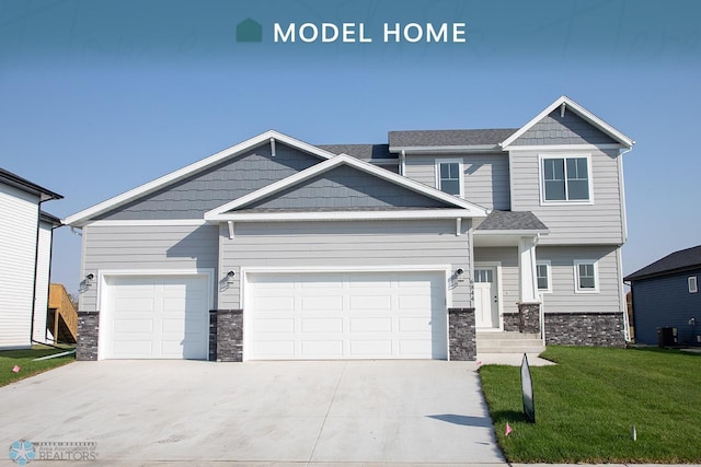 craftsman house featuring a garage, a front lawn, and central AC unit