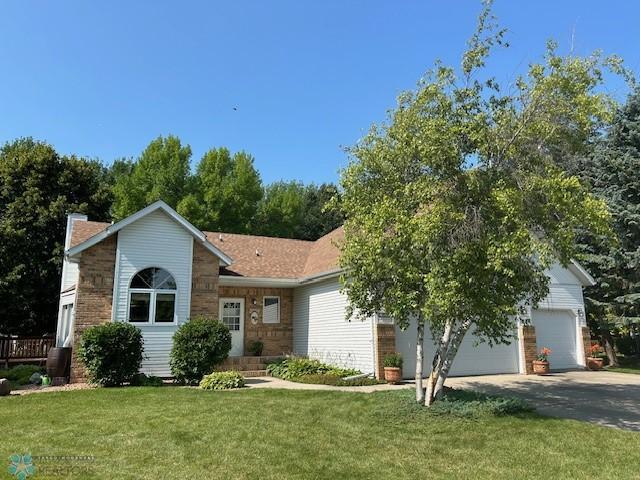 single story home with a garage and a front yard