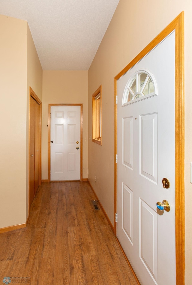 foyer entrance with hardwood / wood-style floors