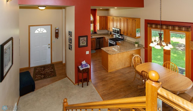 dining area featuring hardwood / wood-style flooring and an inviting chandelier