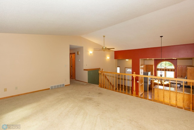 carpeted living room with ceiling fan and lofted ceiling