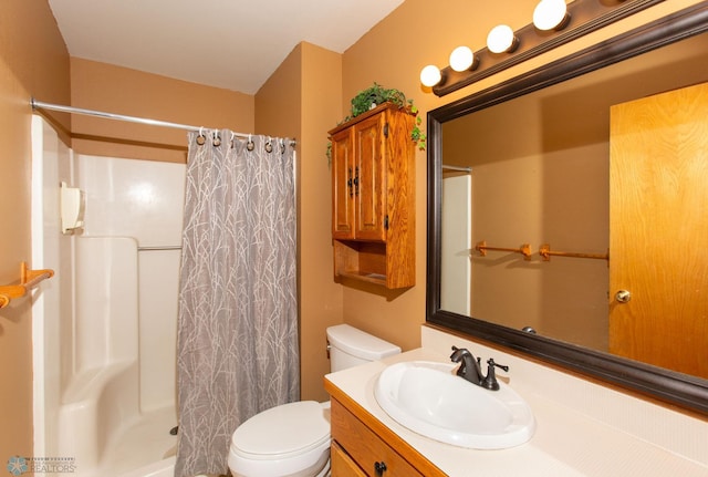 bathroom featuring toilet, vanity, and a shower with curtain