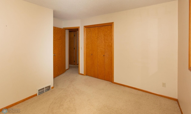 carpeted spare room with a textured ceiling