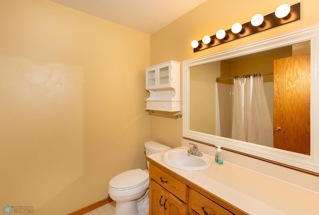 bathroom with toilet, vanity, curtained shower, and tile patterned floors