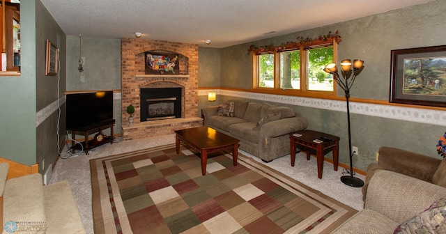 carpeted living room with a textured ceiling, brick wall, and a brick fireplace