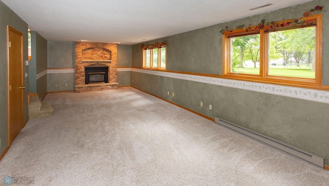 unfurnished living room with carpet floors, baseboard heating, and a brick fireplace