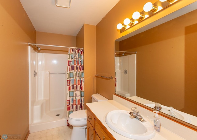 bathroom featuring a shower with shower curtain, tile patterned floors, toilet, and vanity