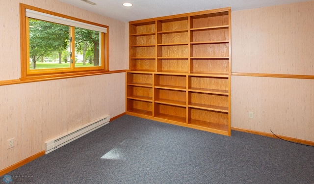 carpeted spare room featuring a baseboard radiator