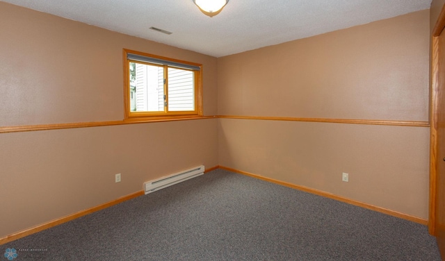 carpeted empty room with a textured ceiling and a baseboard radiator