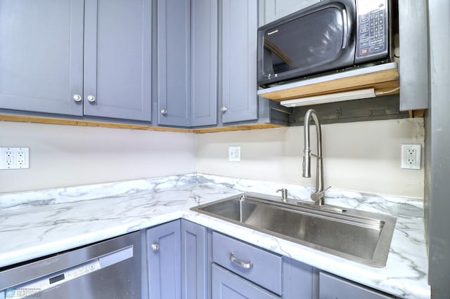 kitchen featuring light stone countertops, sink, dishwasher, and blue cabinetry