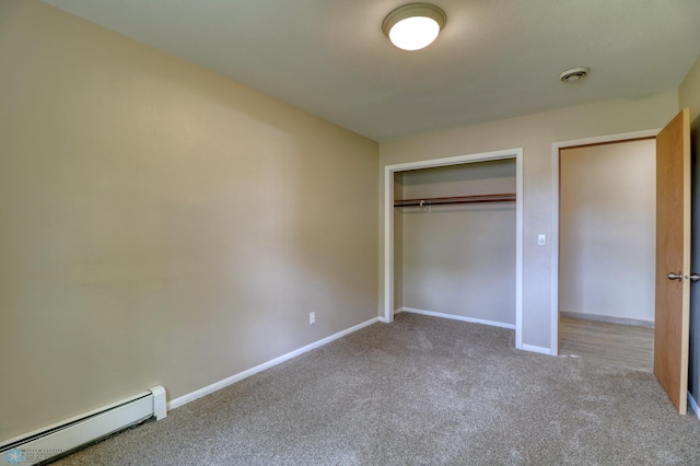 unfurnished bedroom featuring a closet, carpet floors, and baseboard heating