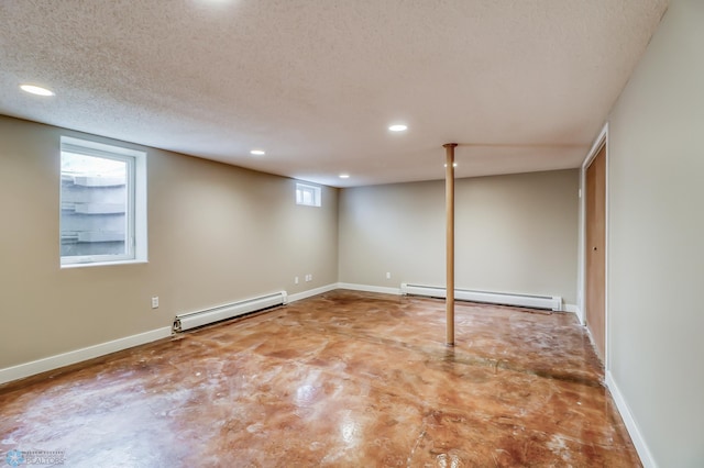 basement with a textured ceiling and baseboard heating