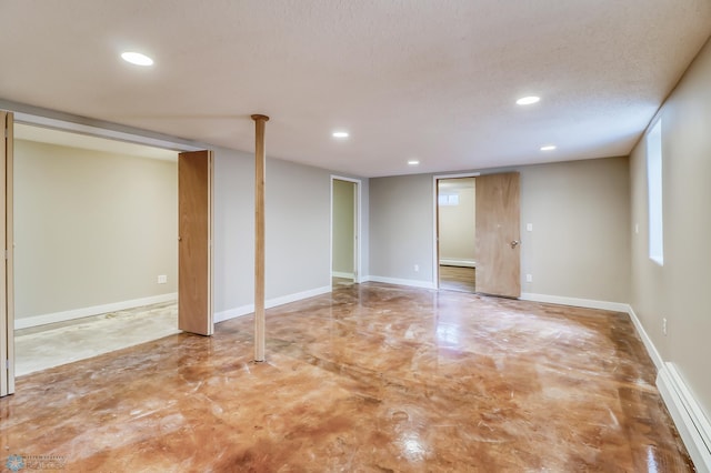 empty room featuring a textured ceiling and baseboard heating