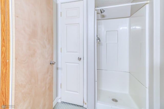 bathroom with walk in shower and tile floors