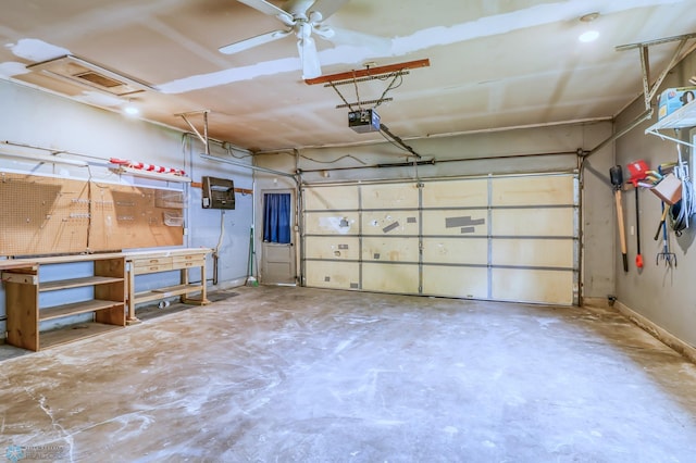 garage featuring a workshop area, a garage door opener, and ceiling fan