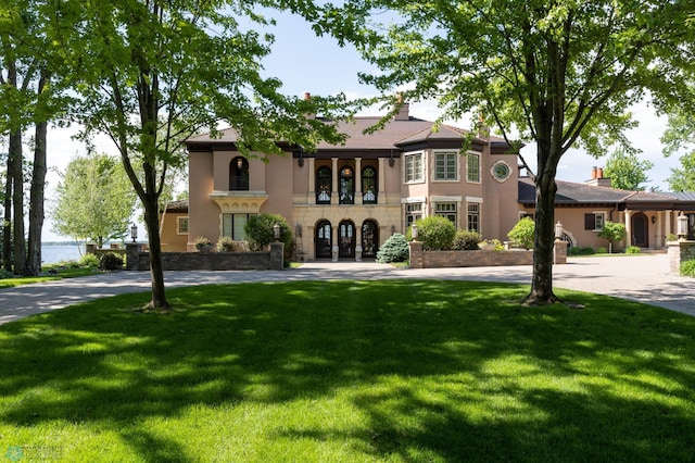 view of front of property with a front yard and french doors