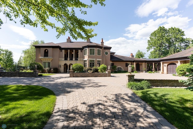 view of front of house with a garage and a front yard