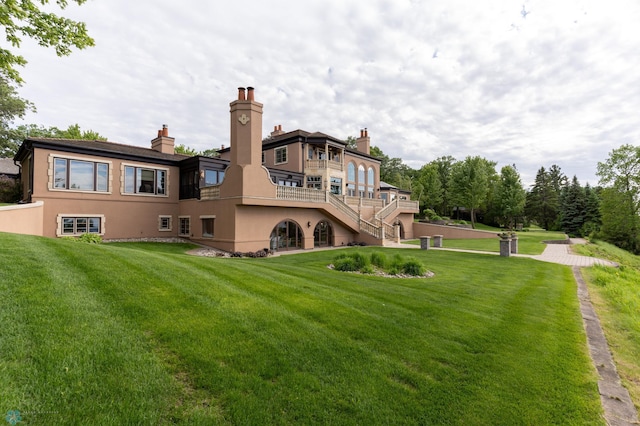 rear view of property with a lawn