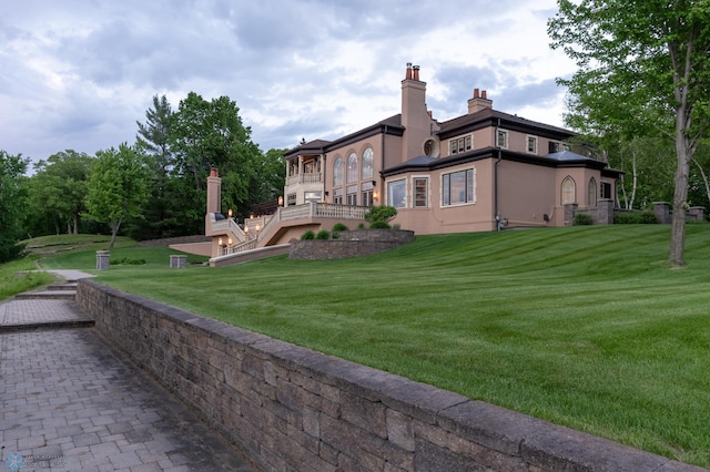 rear view of house featuring a yard